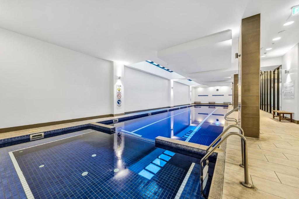 a pool in a building with a swimming pooliterator at Pegasus Apart-Hotel in Melbourne