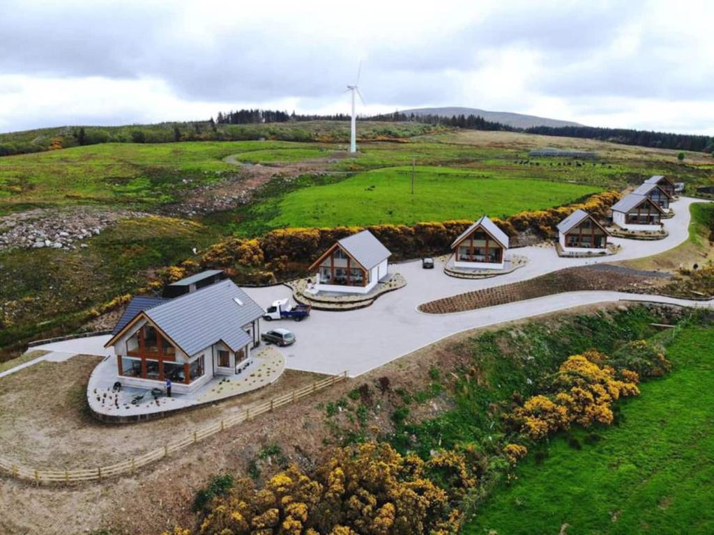 an overhead view of a group of cottages in a field at The Salthouse Lodges in Ballycastle