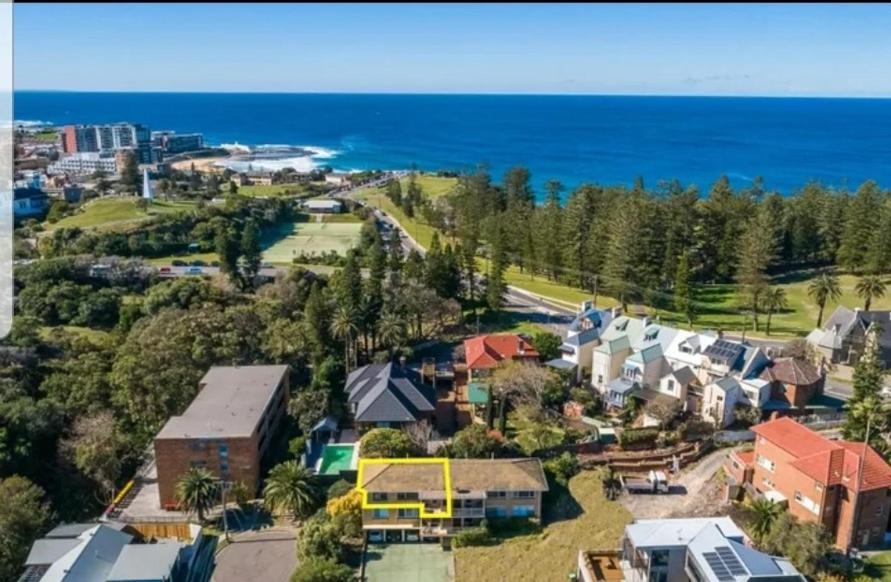 an aerial view of a town with the ocean at Beach Haven on The Hill in Newcastle
