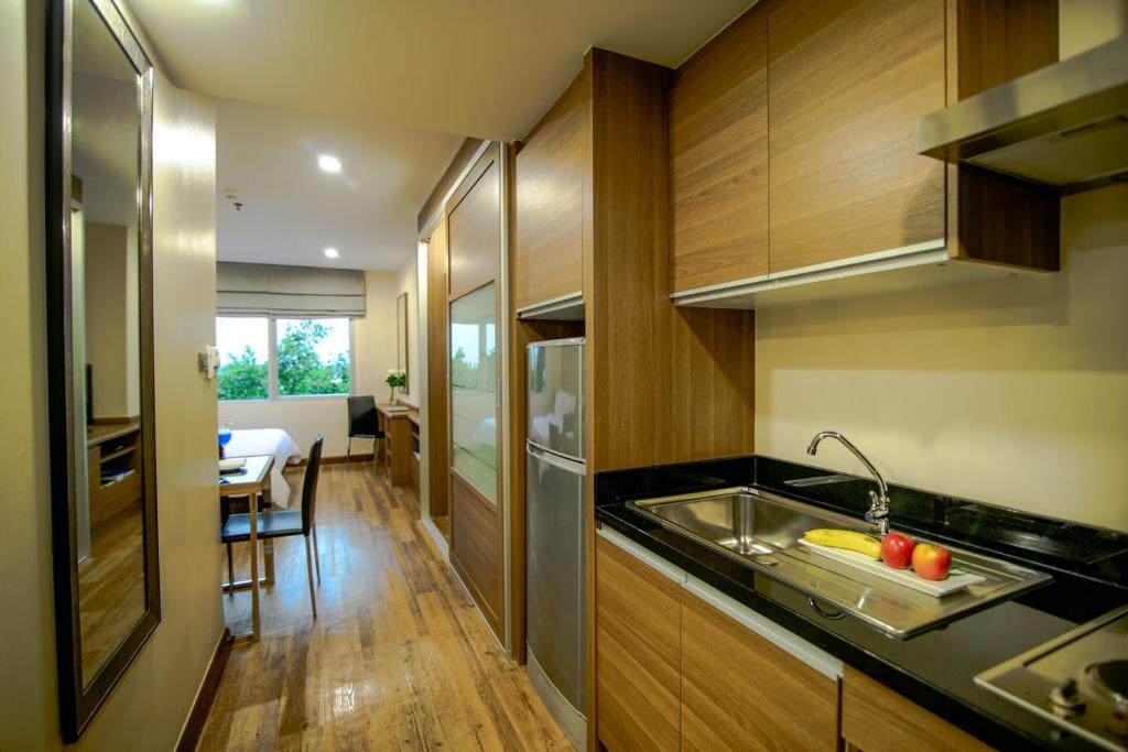a kitchen with a sink and a counter top at Sima Thani Hotel in Nakhon Ratchasima