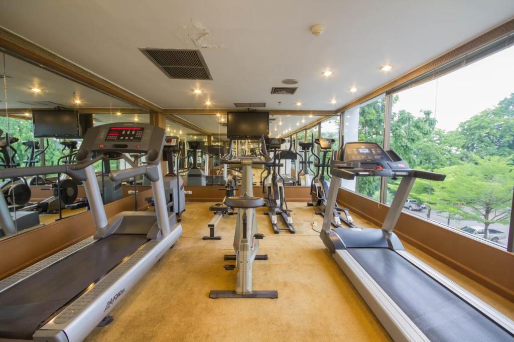a gym with treadmills and elliptical machines at Sima Thani Hotel in Nakhon Ratchasima