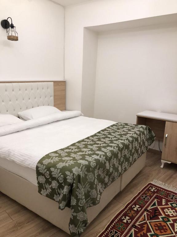 Postel nebo postele na pokoji v ubytování Ziyagil Konağı