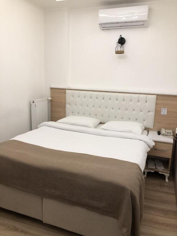 Postel nebo postele na pokoji v ubytování Ziyagil Konağı