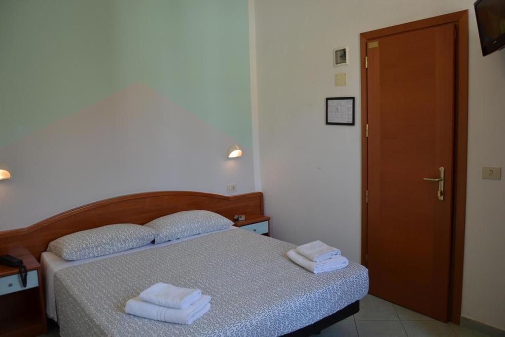 Łóżko lub łóżka w pokoju w obiekcie Hotel Villa Caterina