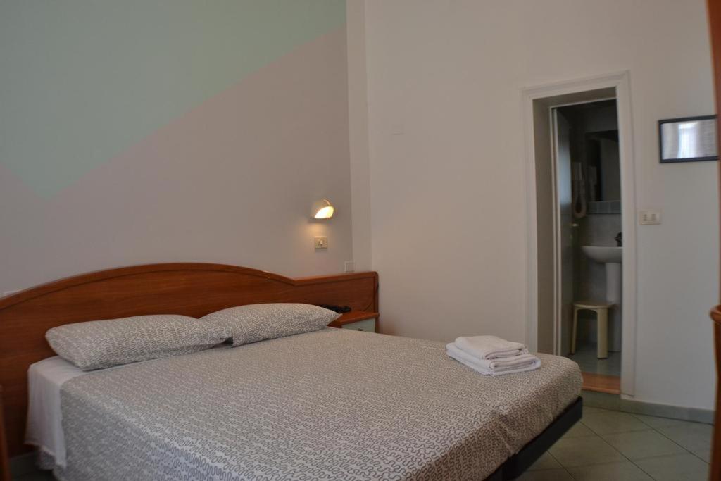 Łóżko lub łóżka w pokoju w obiekcie Hotel Villa Caterina