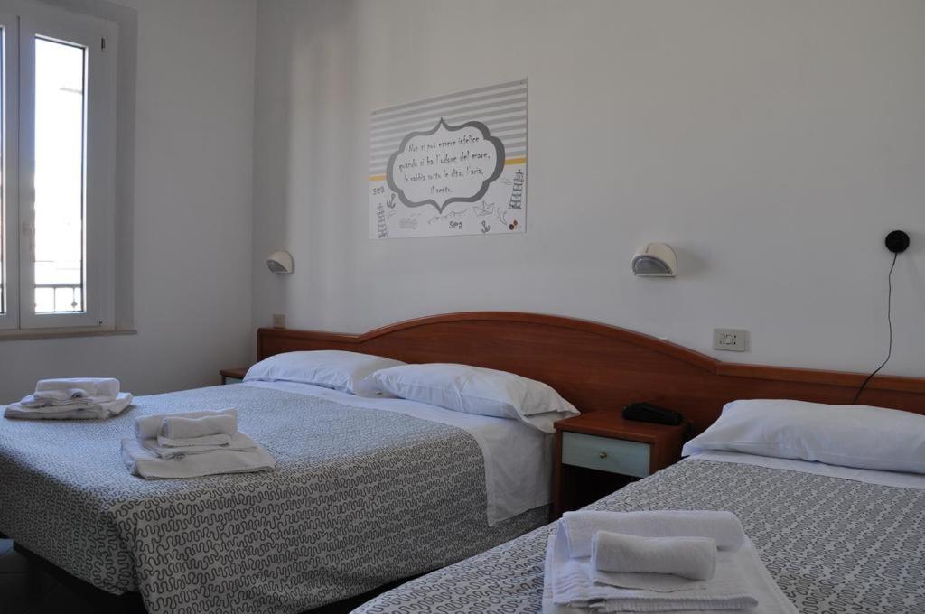 Łóżko lub łóżka w pokoju w obiekcie Hotel Villa Caterina