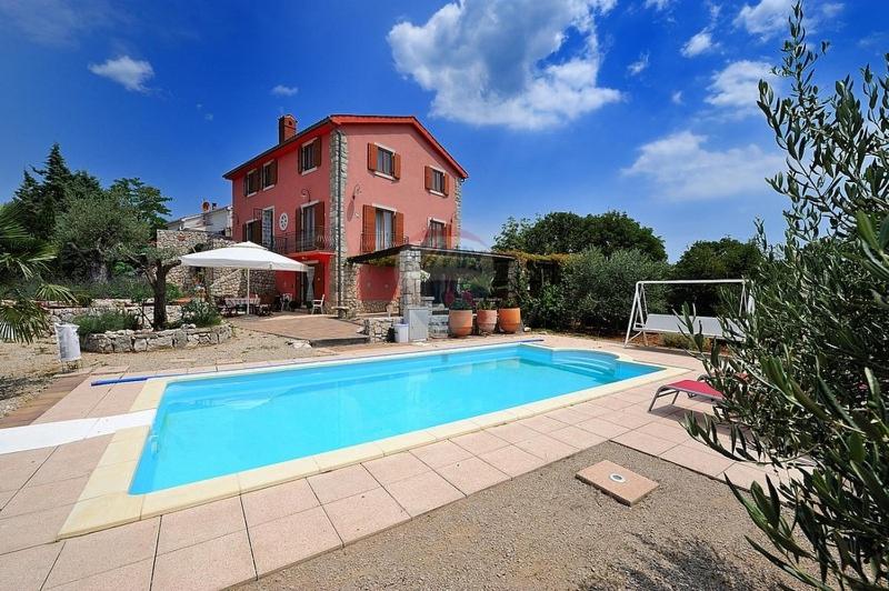 a large swimming pool in front of a house at Villa Garica in Garica