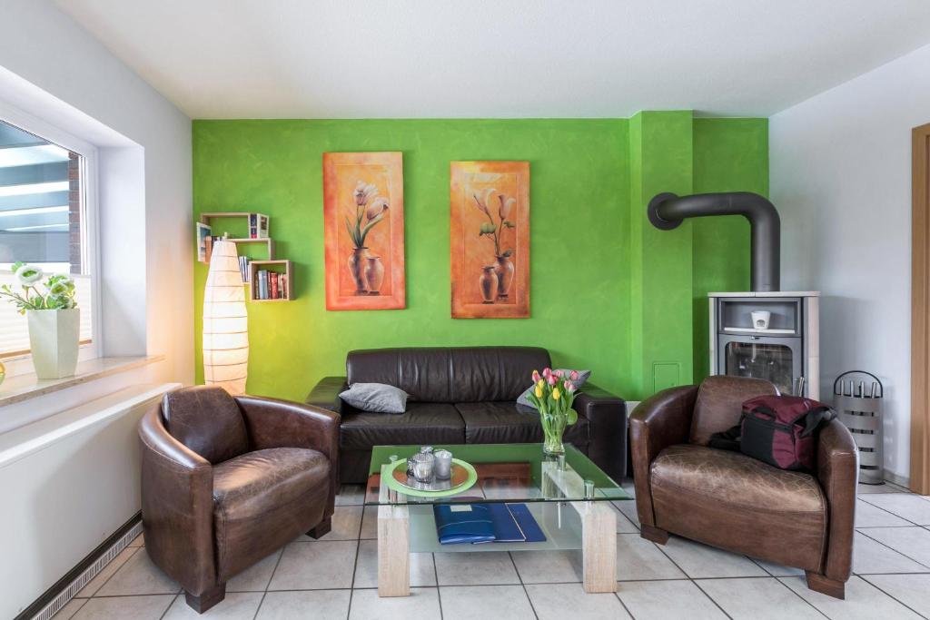 a living room with a couch and two chairs at Ferienhaus Kikki in Friedrichskoog-Spitz