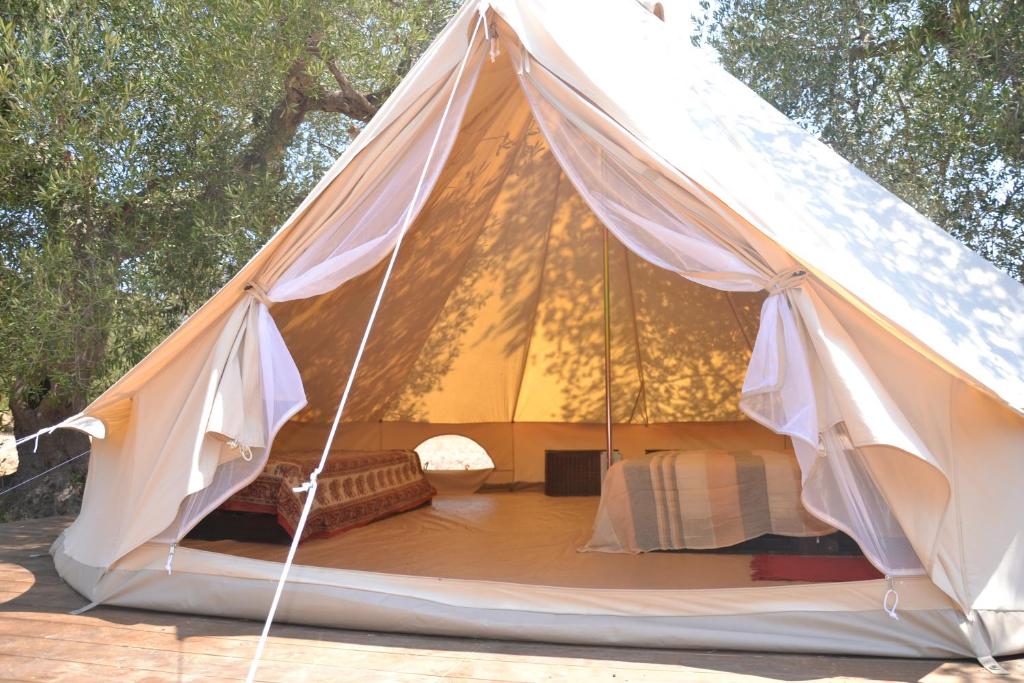 a teepee tent with a bed in it at Macarìa Agricampeggio in Alliste