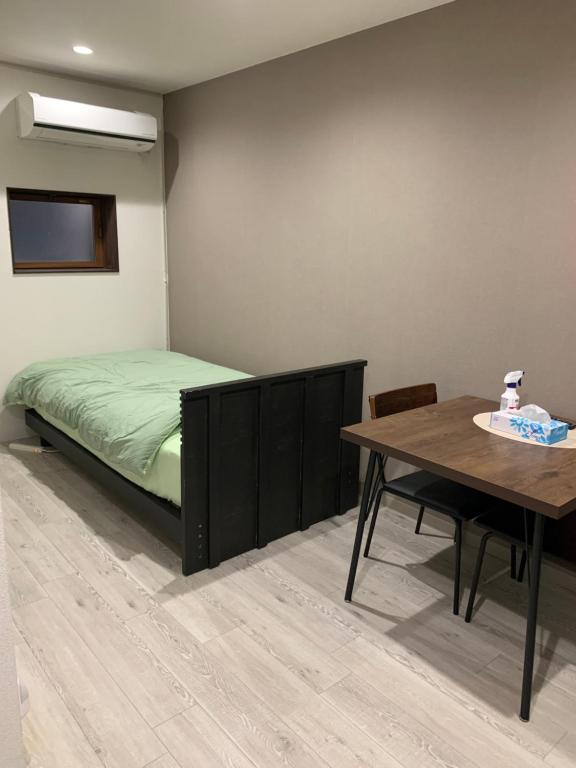 Postel nebo postele na pokoji v ubytování Suzumaru Hotel