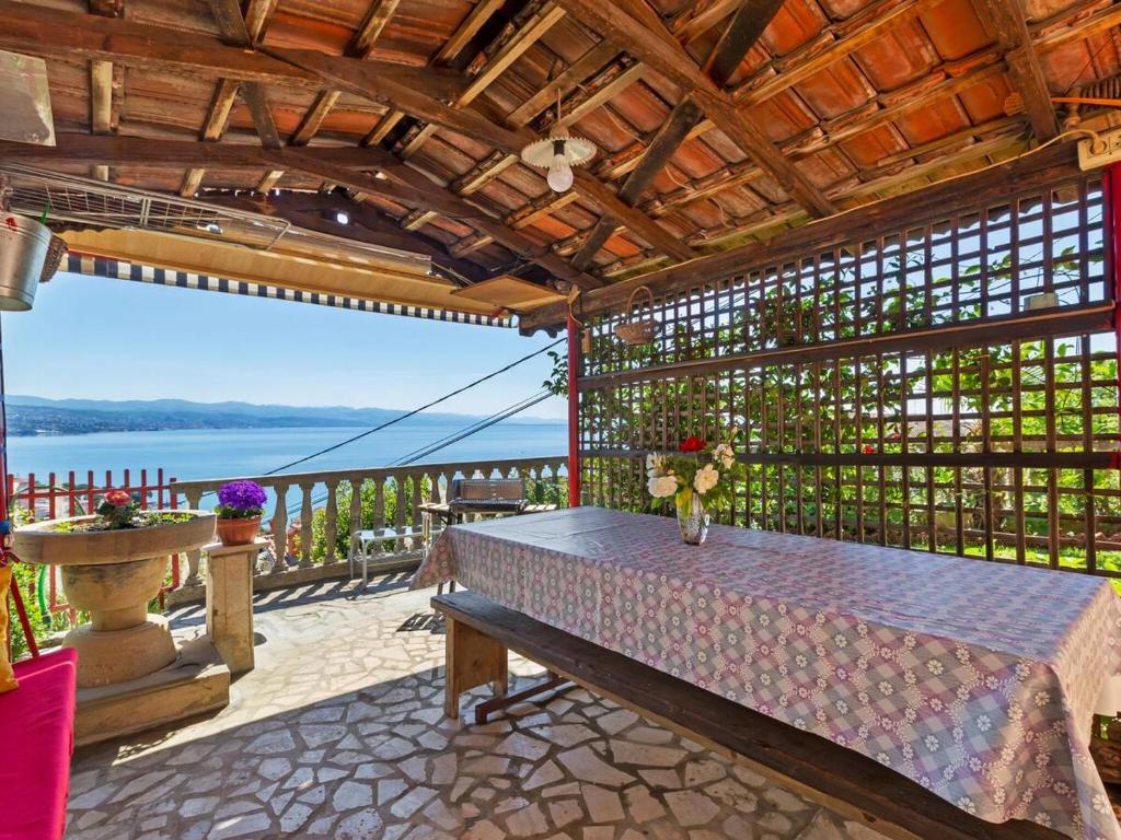 a table on a patio with a view of the water at Top view in Opatija