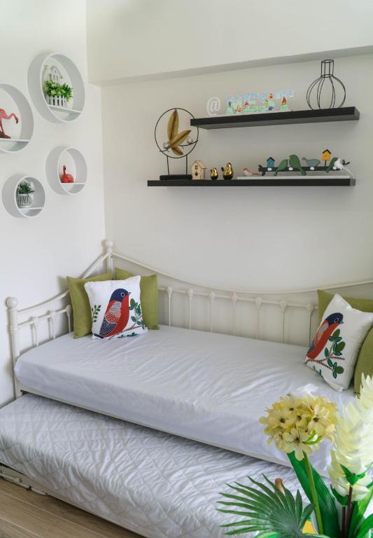a bedroom with a bed with white sheets and pillows at An Oasis in Tagaytay in Tagaytay