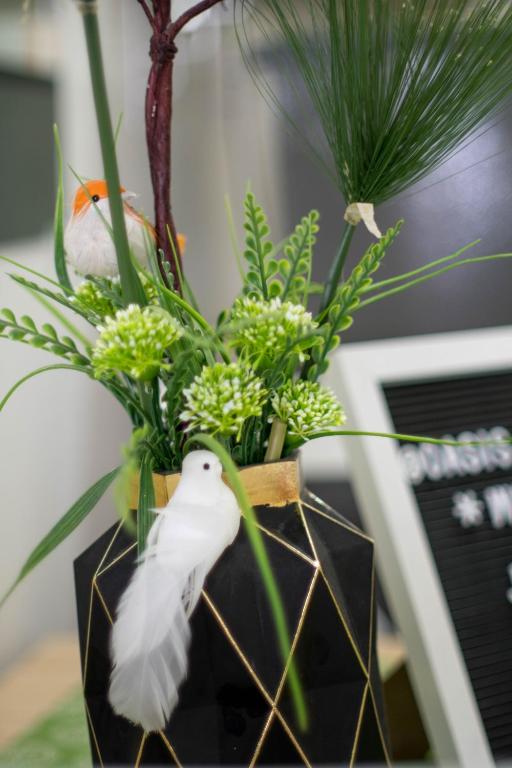 a vase with a plant with a bird on it at An Oasis in Tagaytay in Tagaytay