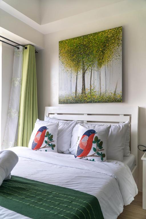 a bedroom with a bed with two birds on it at An Oasis in Tagaytay in Tagaytay