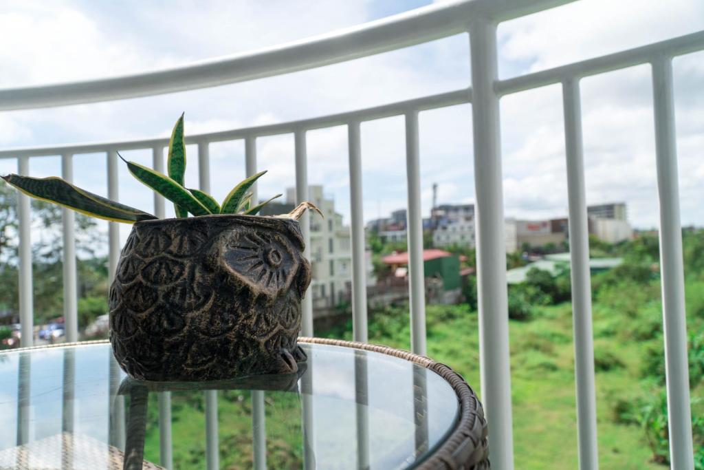 a plant sitting on top of a glass table on a balcony at An Oasis in Tagaytay in Tagaytay