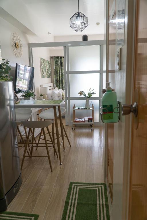 a living room with a table and chairs and a kitchen at An Oasis in Tagaytay in Tagaytay