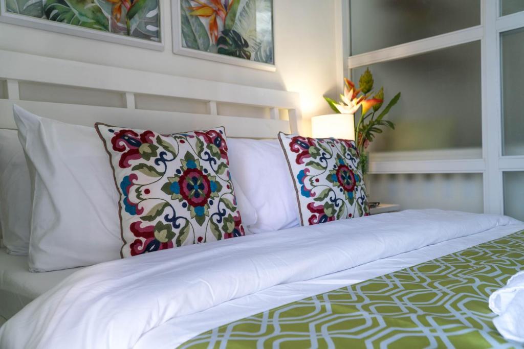 a bed with pillows on it in a room at An Oasis in Tagaytay in Tagaytay