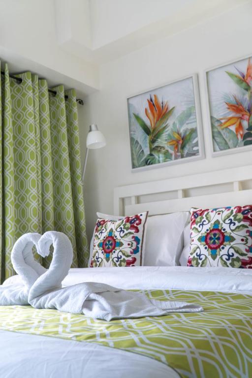 a bed with swan towels on top of it at An Oasis in Tagaytay in Tagaytay