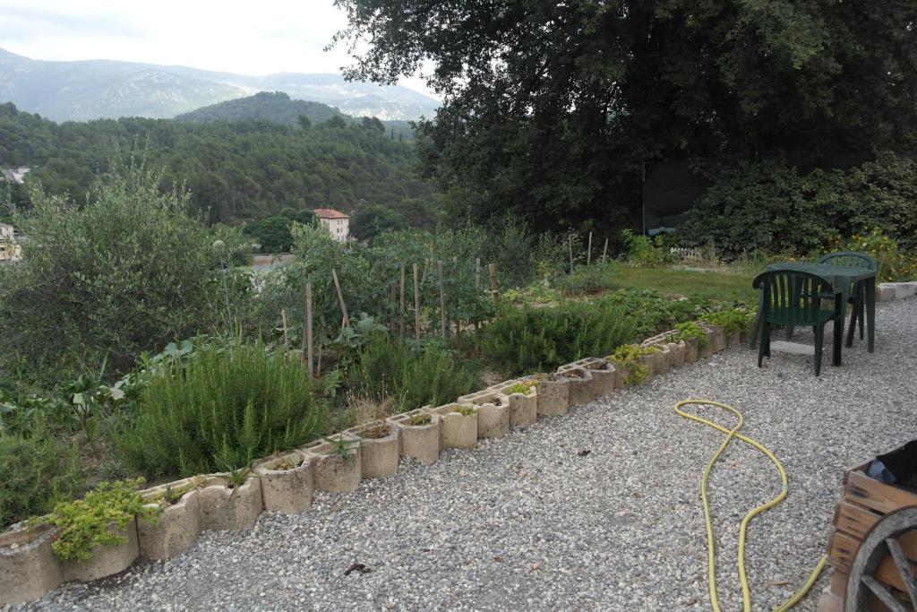 a bench sitting in a garden with a view at Studio 30 m2 in Contes