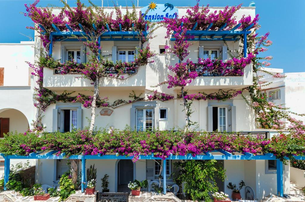 a building with flowers on the side of it at Pension Sofi in Naxos Chora