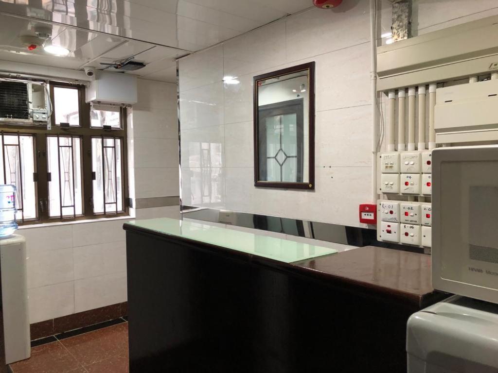 a large kitchen with a counter in a room at Crystal Hostel in Hong Kong