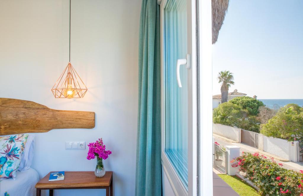 a room with a window with a view of the ocean at Fortuna in Los Caños de Meca