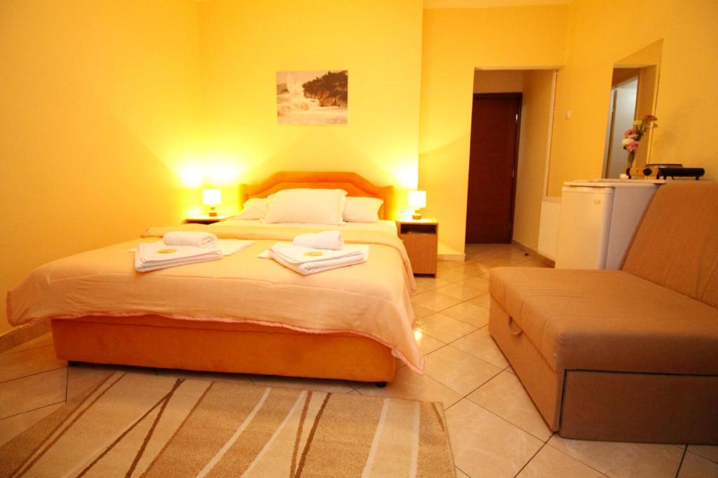 a bedroom with a bed with two towels on it at Apartments Mitrovići Miločer in Sveti Stefan