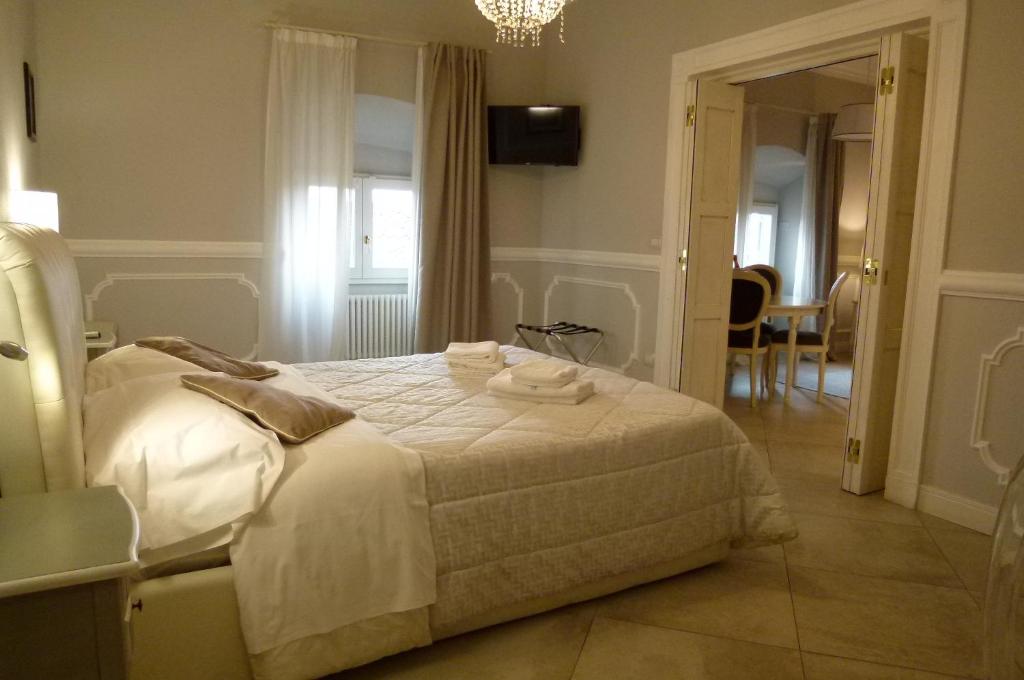 a bedroom with a bed with towels on it at Brunelleschi suite in Florence