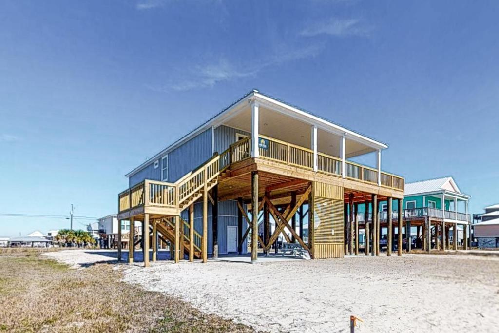 a large wooden house on the beach at Latitude Adjustment in Dauphin Island