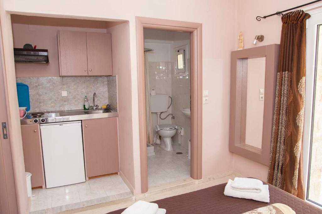a small bathroom with a toilet and a sink and a sink at Fantastic Matala 1 in Matala