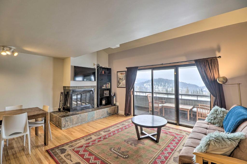 a living room with a couch and a fireplace at Whitefish Mtn Ski-in and Out Condo Steps to Slopes! in Whitefish