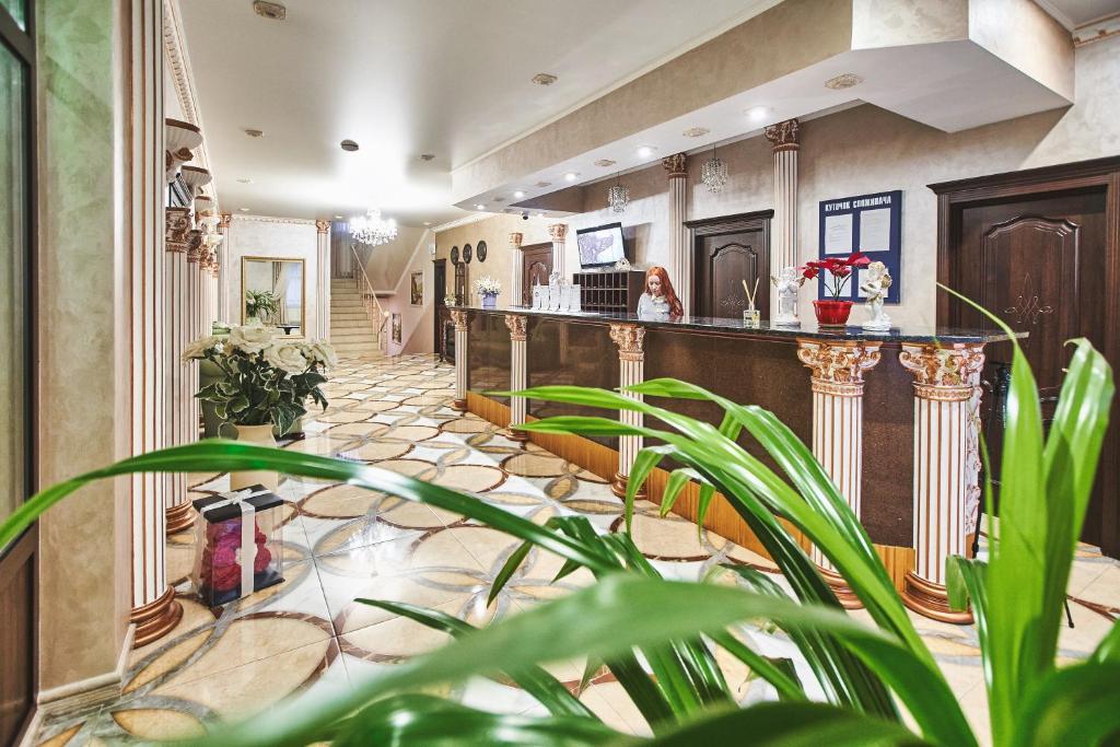 a lobby with a bar and plants at Ангел комфорт in Kyiv