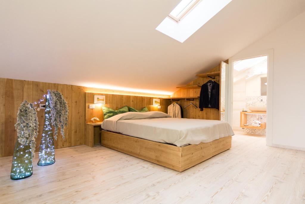 a bedroom with a bed in a room with wooden walls at B&B COL DE LE MOLE - DOLOMITI BELLUNESI in Belluno