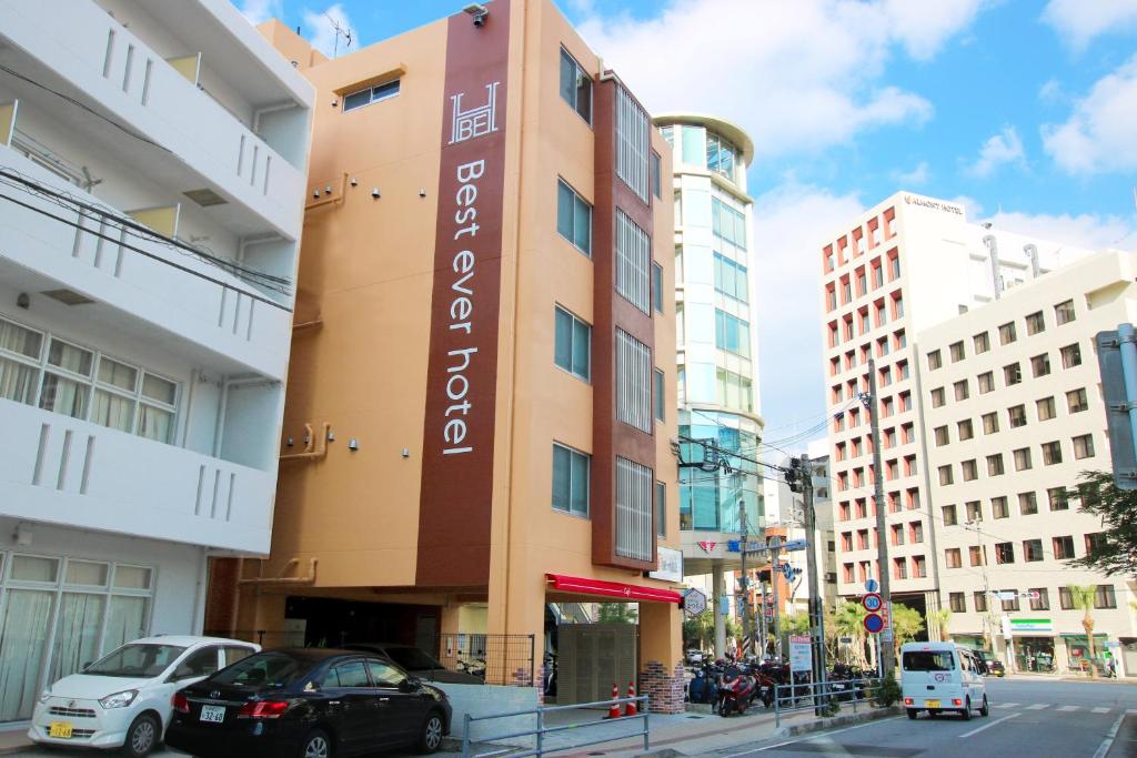 a building with a sign on the side of it at Best ever hotel -SEVEN Hotels and Resorts- in Naha