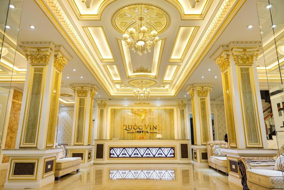 a large lobby with a gold ceiling and a store at Quoc Vinh Hotel in Rạch Giá