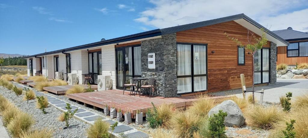 a house with a wooden deck in front of it at Star View in Lake Tekapo