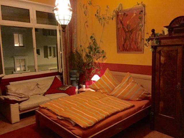 a bedroom with a bed with pillows and a window at Mediterranean Room - Private Room in Mannheim