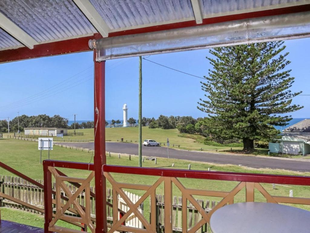 a view from a porch with a view of a field at Reflections Yamba Lighthouse Cottages in Yamba