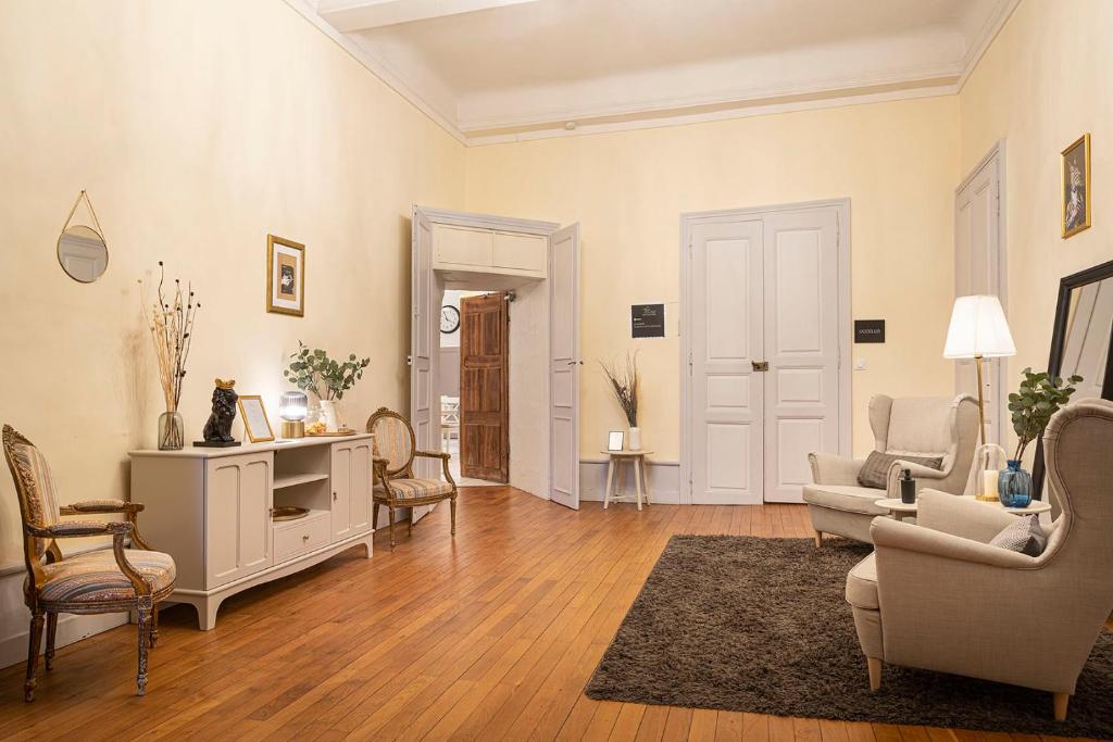 a living room with a couch and chairs and a table at Les Suites de Sautet in Chambéry