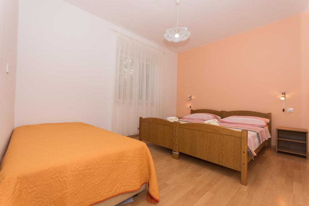 Posteľ alebo postele v izbe v ubytovaní Apartments Mastelić