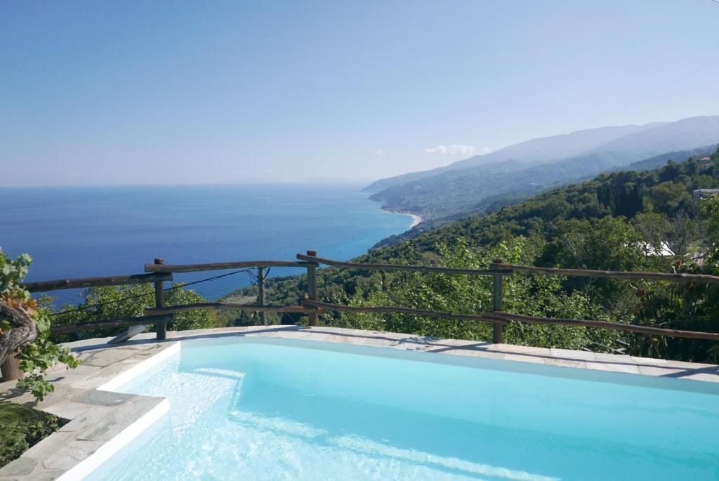 a swimming pool with a view of the ocean at Villa Asterina in Pouríon