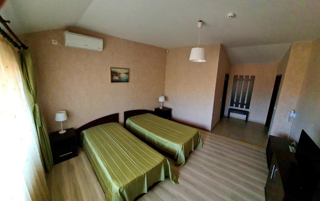 a room with two beds in a hotel room at La Salcii in Călăraşi