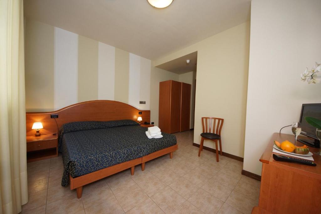 Postel nebo postele na pokoji v ubytování Hotel Residence La Rotonda