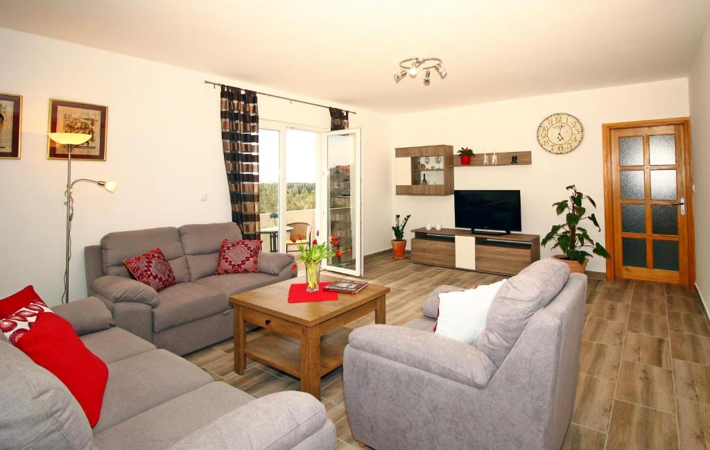 a living room with two couches and a tv at Apartment Milenka in Čilipi