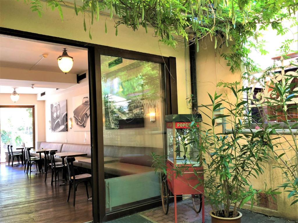 a restaurant with potted plants on the side of the building at Hotel Neufeld in Zürich