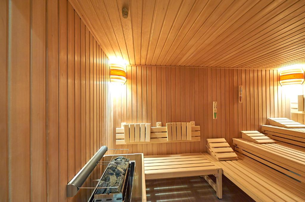 a sauna with two chairs and a table in it at Hotel Belvedere in Warnemünde