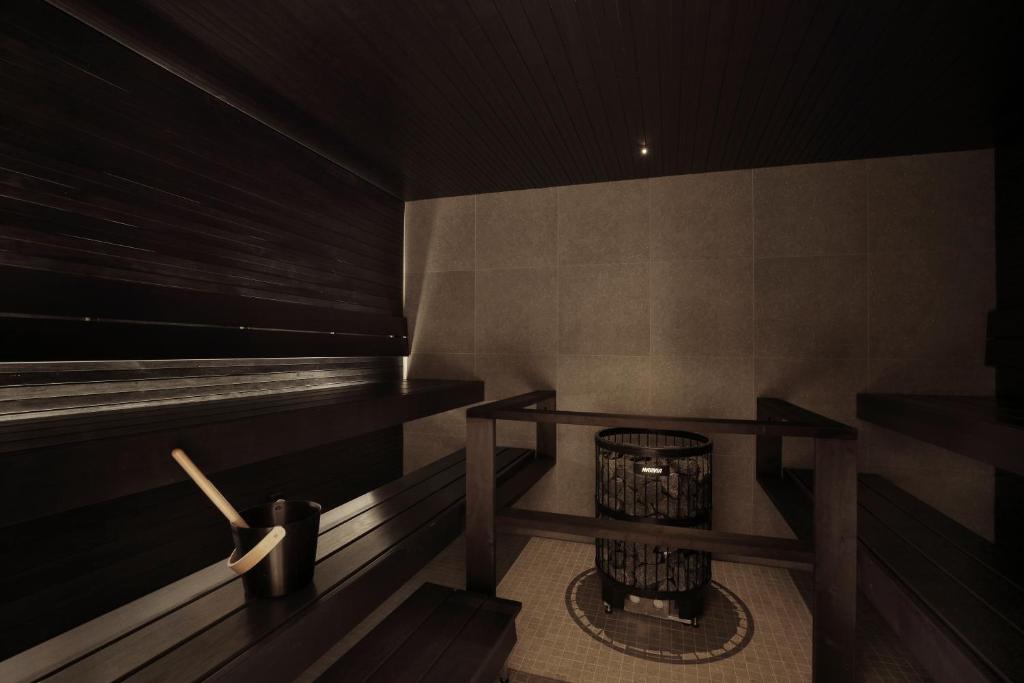 a sauna with a trash can in a room at VALO Hotel & Work Helsinki in Helsinki