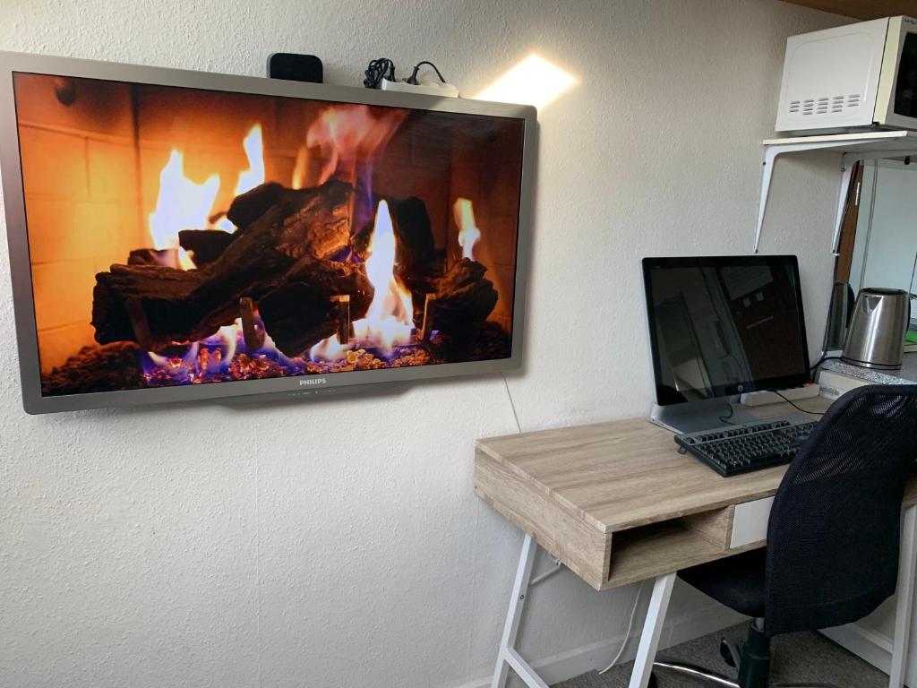 a flat screen tv hanging on a wall at Central & Cosy Studio + Free Bikes & Netflix in Copenhagen