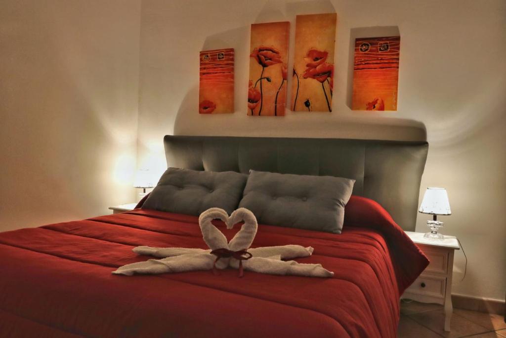 a stuffed animal on a bed with a heart on it at Casa Palazzo Reale in Palermo