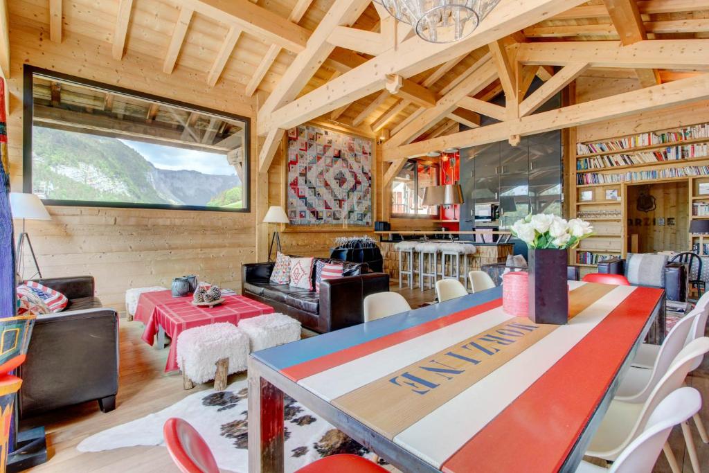 a living room with a table and chairs at Igloo in Morzine